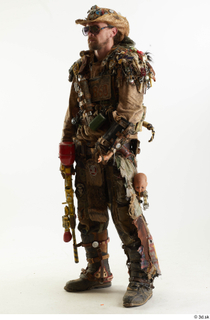 Ryan Miles in Junk Town Postapocalyptic Bobby Suit holding gun…